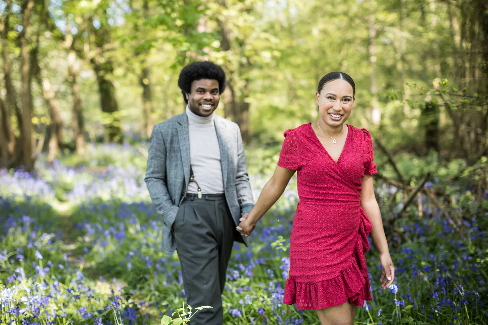 Engagement Photo Shoot - couple walking together in bluebell woodland in West Sussex