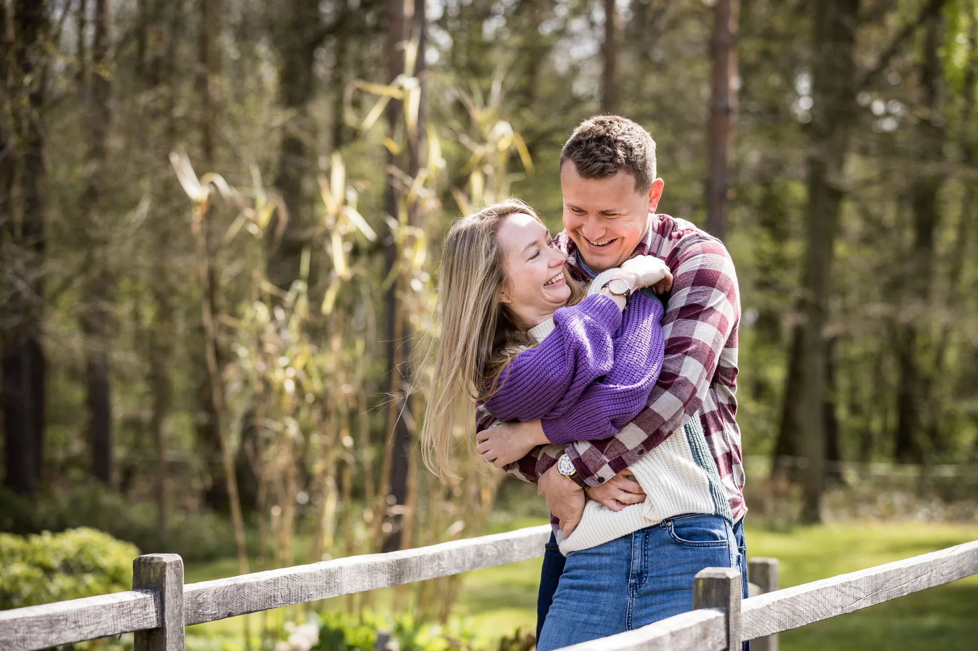 Engagement Photo Shoot - couple playfully embraced together in woodland in Essex