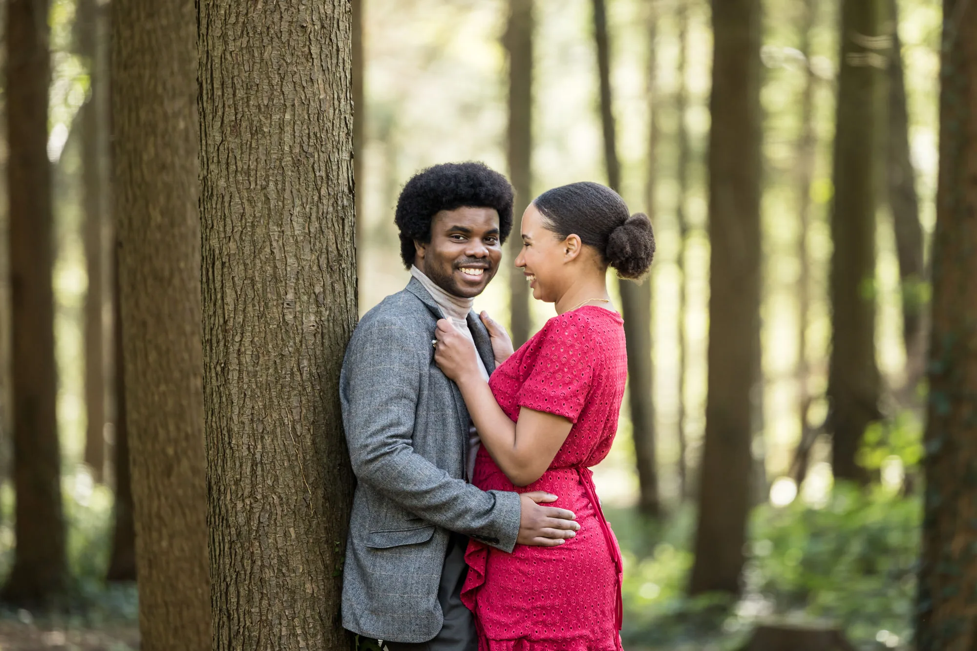 Engagement Photo Shoot - BAME couple in woodland share an intimate moment.