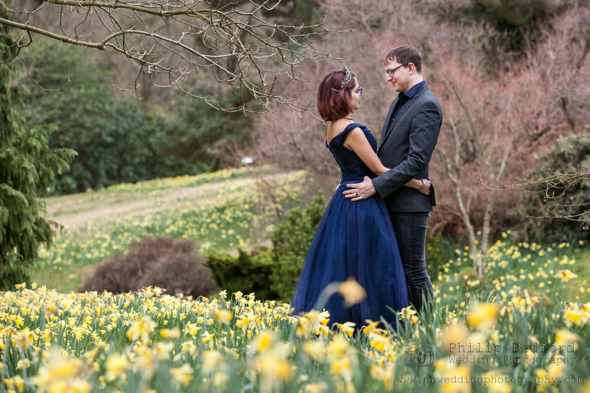 Engagement Photo Shoot - bride and groom and engagement attire in a field of daffodils