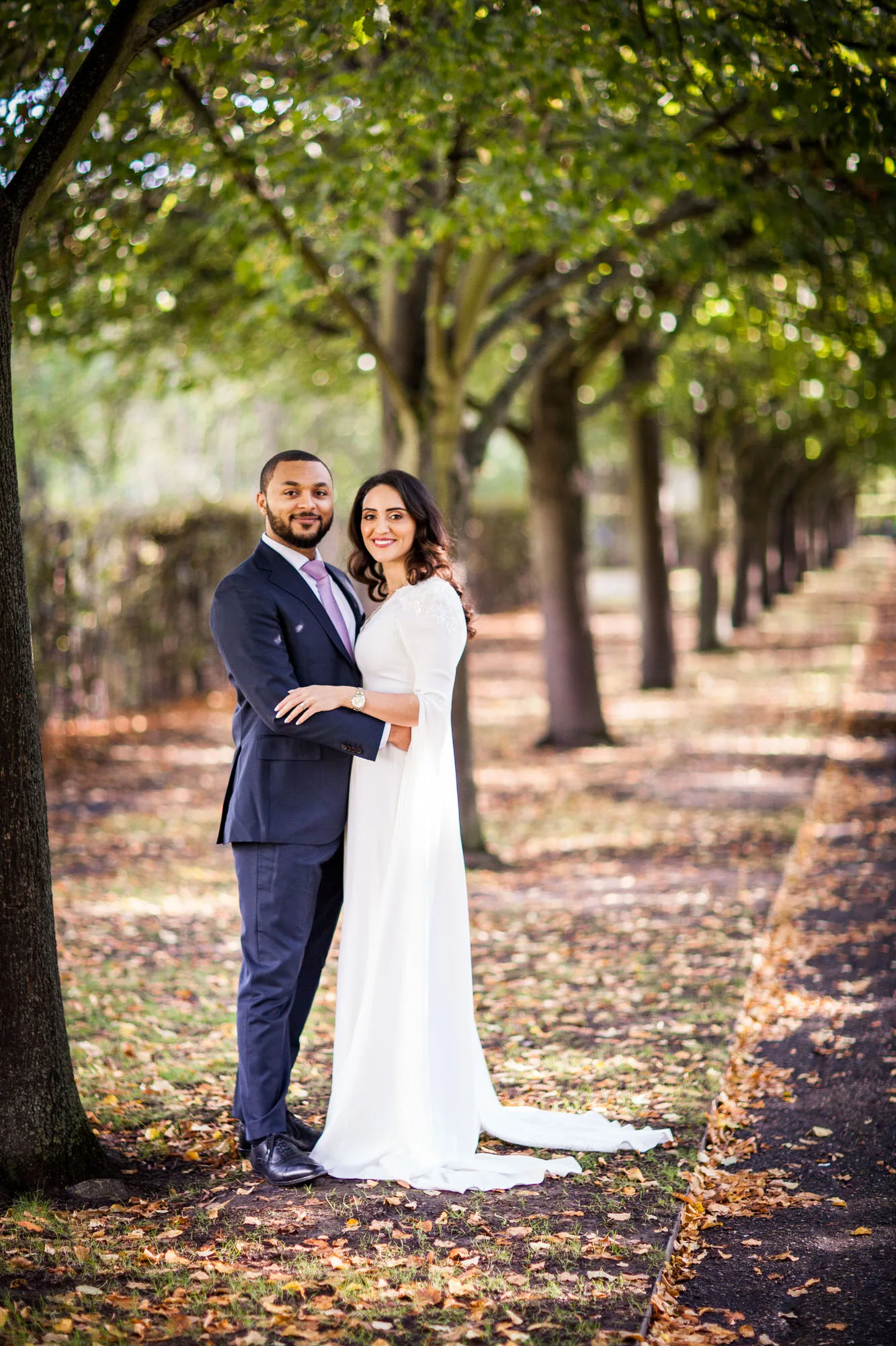 Engagement Photo Shoot - bride and groom under an avenue of trees in Greenwich Park in London.