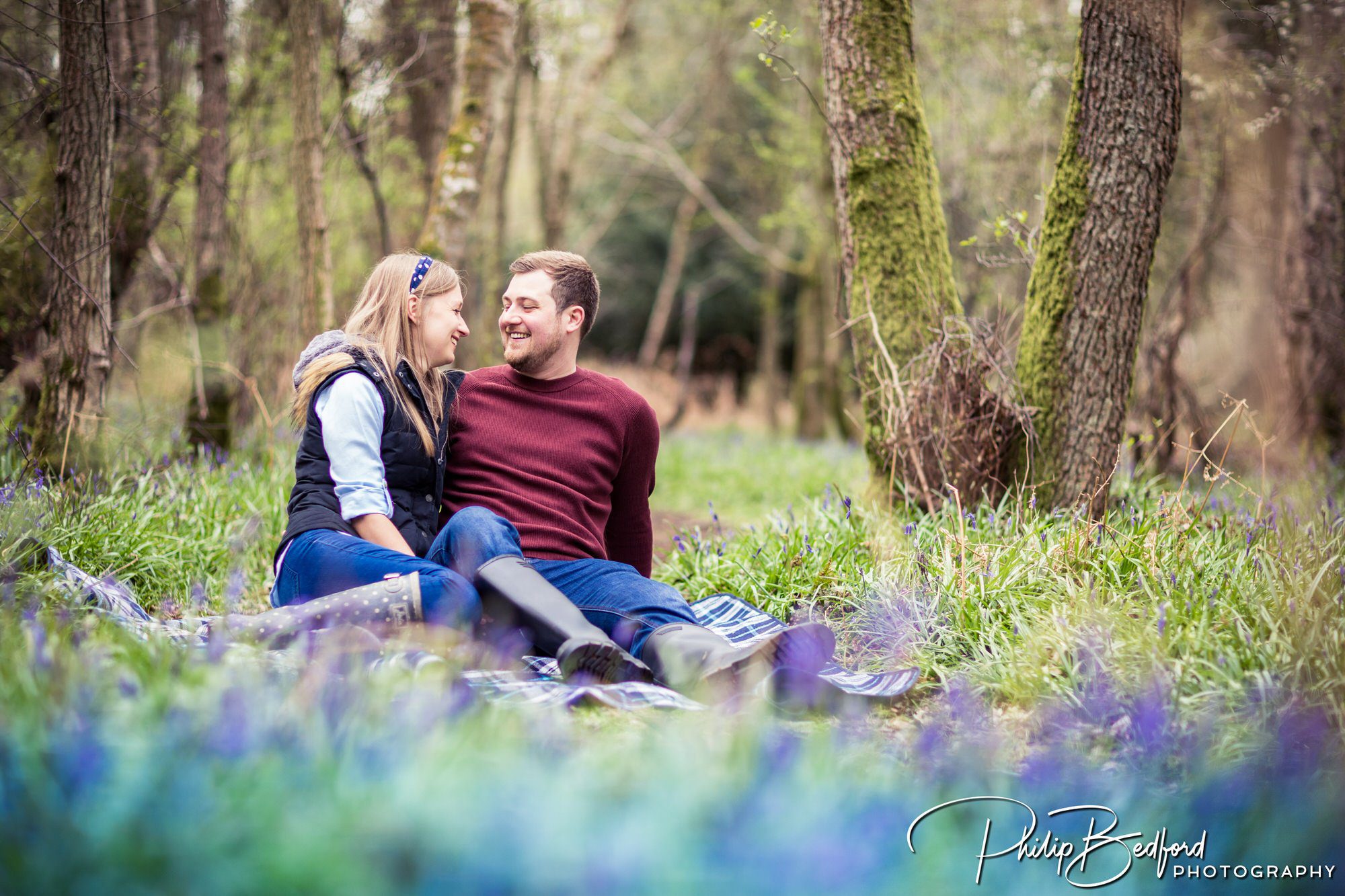 A Couple On A Woodland Engagement Shoot Amongst Bluebells