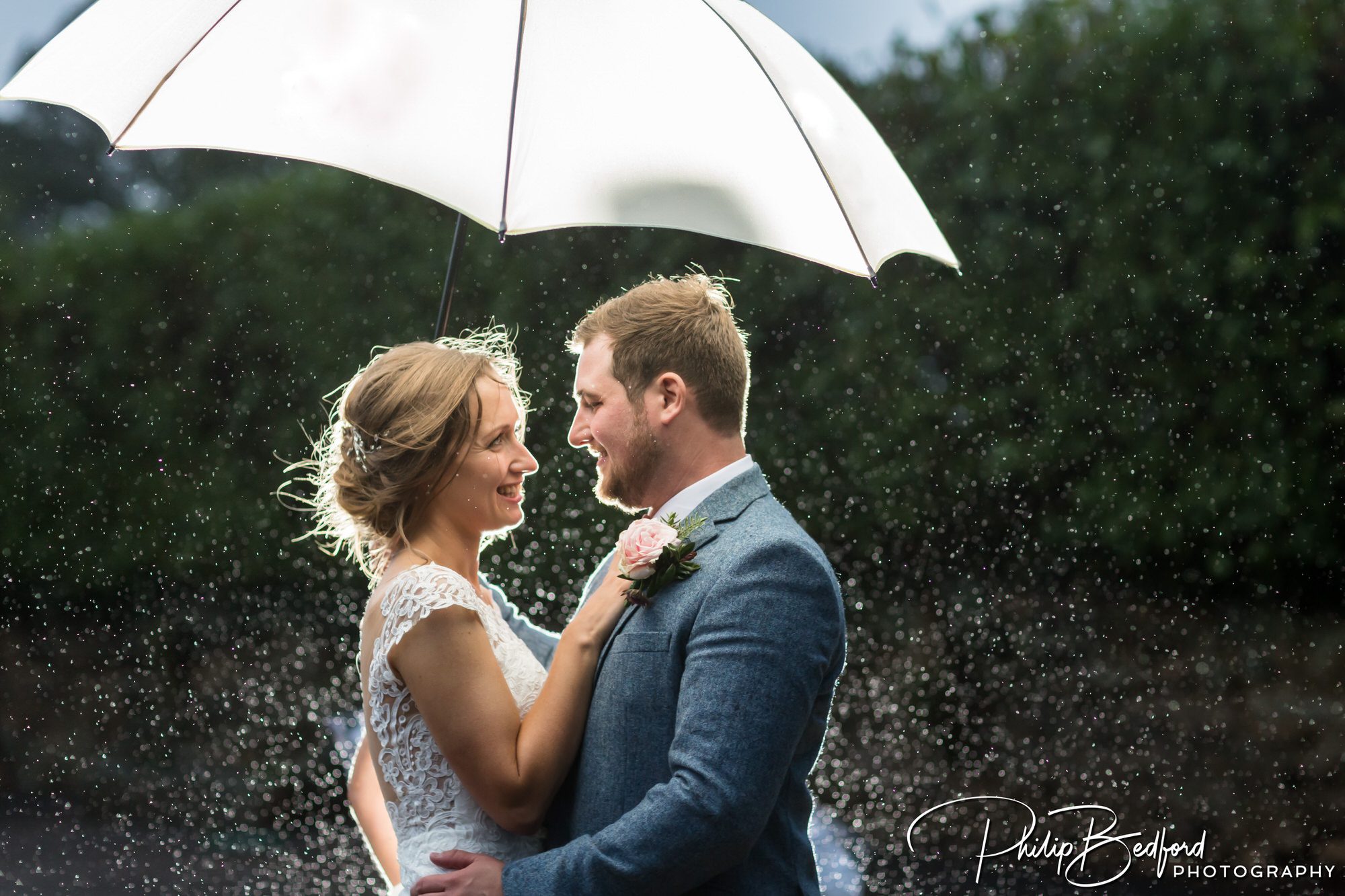 Fitzleroi Barn Autumn Wedding: Bride & Groom under an umbrella