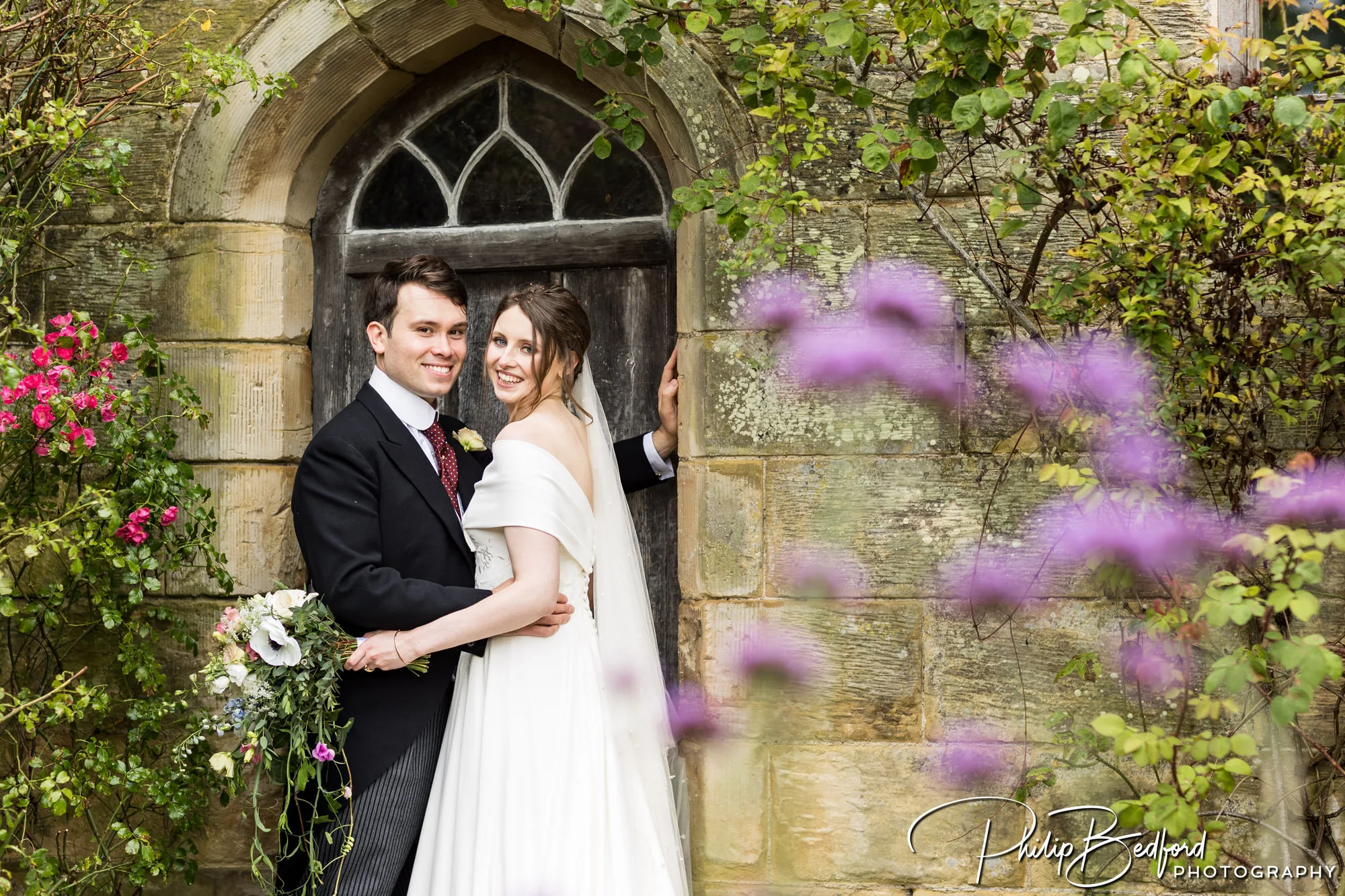 Chiddingstone Castle Wedding - bride and groom by the castle